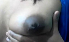 Squeezes out milk from her dark nip ttis